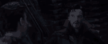 doctor strange and spider-man are talking to each other in a dark room in a movie .