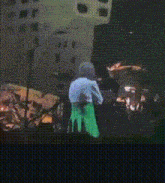 a blurred image of a person in a green dress
