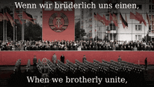 a large crowd of people are gathered in front of a large red banner that says ddr