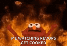 elmo is standing in front of a fire and says `` me watching revols get cooked '' .