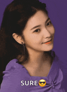 a woman wearing sunglasses and a purple shirt has the word sure above her head