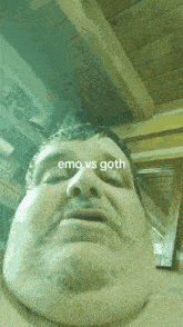a close up of a man 's face with the words emo vs goth above him