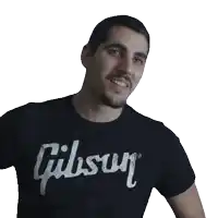 a man wearing a black gibson t-shirt smiles