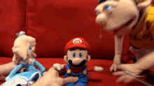 a mario doll is being held by a person