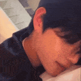 a close up of a person 's face with their eyes closed and their mouth open .