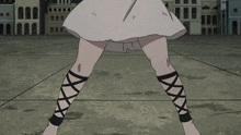 a woman in a white dress and black lace up socks stands on a concrete floor