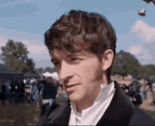 a close up of a man with a bee in the background