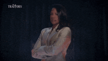 a woman named natalie anderson is standing in front of a dark background