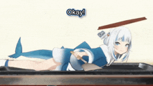 a girl with a shark tail is laying on a table and says okay !