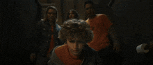 a man in a blue hoodie is being attacked by a monster in a dark room