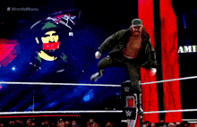 a wrestler is walking out of a wrestling ring with a crowd behind him