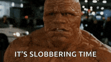 a close up of a man with the words `` it 's slobbering time '' written on his face .