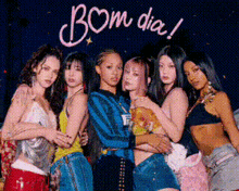 a group of women are posing for a picture with the words bom dia written in the background .