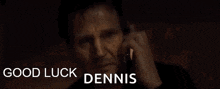 a man is talking on a cell phone with the words good luck dennis below him