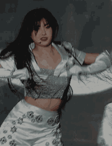 a woman wearing a crop top and white gloves