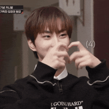 a young man wearing a black sweater that says going hard on it