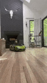 a cat is sitting in a toy car in a living room