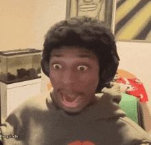 a man wearing headphones is making a funny face with his mouth open and the words " hoghands " below him