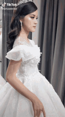 a woman in a wedding dress with a tiktok watermark on the bottom right