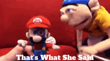 a mario puppet is being held by another mario puppet