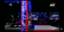 a man in a blue shirt is jumping on a trampoline in front of a tv8 logo
