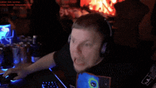 a man wearing headphones sits in front of a computer