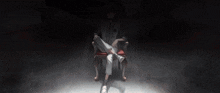 a person is sitting in a chair with their legs crossed in a dark room