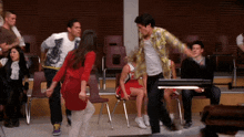 a woman in a red dress is dancing with a man in a plaid shirt