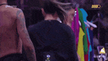 two women are dancing on a stage in front of a sign that says bbbo .