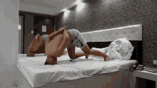 a man is laying on his back on a bed in a room