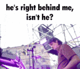 a man playing a keyboard with the caption he 's right behind me is n't he