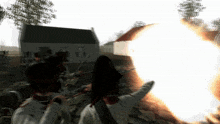 a group of soldiers are firing guns in front of a white building