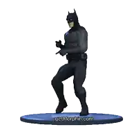 a statue of batman is dancing on a blue base