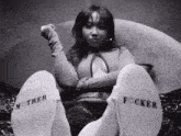 a woman wearing a pair of white socks that say mother and focker