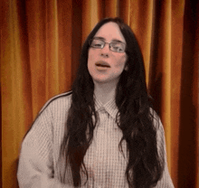 a woman wearing glasses and a plaid shirt