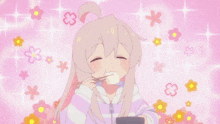 a girl is eating something with chopsticks in front of a pink background with flowers