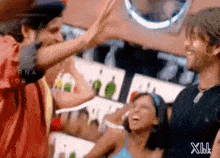 a group of people are giving each other a high five in a restaurant .