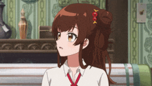 a girl with brown hair and a red bow in her hair is sitting on a couch