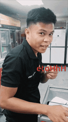 a young man in a black shirt with the word etohh on the bottom
