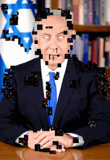a man in a suit and tie is sitting at a desk with his hands folded
