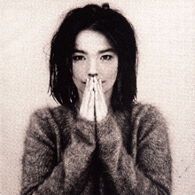 a black and white photo of a woman with her hands on her mouth