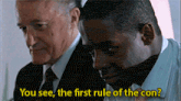 a man says " you see the first rule of the con " while another man looks on