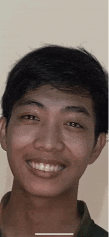 a close up of a young man 's face smiling .