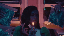 a woman is lighting a cigarette in front of a pile of marijuana bags