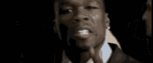 a close up of a man 's face in a suit