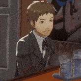 a man in a suit and tie is sitting at a counter