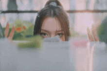 a close up of a woman 's face looking out of a window
