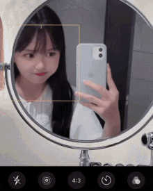 a girl is taking a picture of herself in a mirror with the time 4:33