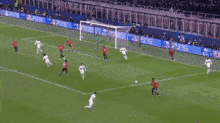 a soccer game is being played on a field with ps5 advertisements along the sidelines .