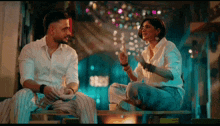 a man and a woman are sitting on a bench and talking to each other .